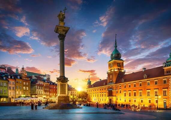 Sigismund’s Column and Royal Castle in Warsaw at sunset